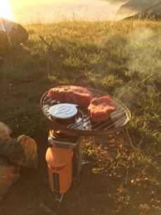 Grilling steaks on the BioLite stove with grill