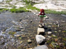 Joan Crossing a Creek